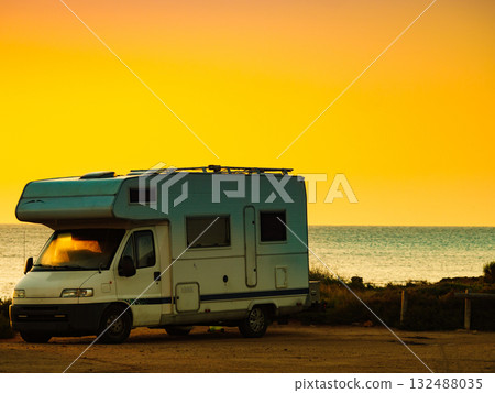 Camper car on beach at sunrise 132488035