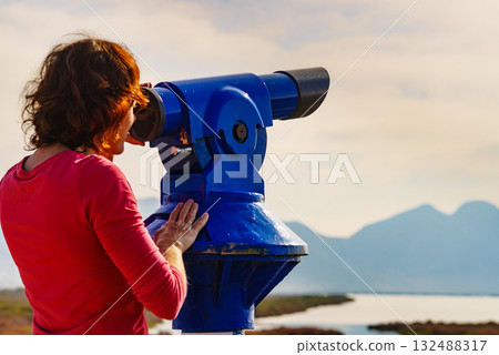 Woman using tourist binoculars, Cabo de Gata, Spain Woman using tourist binoculars, Cabo de Gata, Spain 132488317