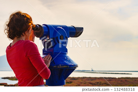 Woman using tourist binoculars, Cabo de Gata, Spain Woman using tourist binoculars, Cabo de Gata, Spain 132488318