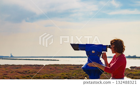 Woman using tourist binoculars, Cabo de Gata, Spain Woman using tourist binoculars, Cabo de Gata, Spain 132488321