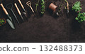 Gardening tools and plants on fertile soil background 132488373