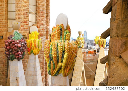 Sculptures of fruit and grain symbolizing the birth of Christ on top of the Sagrada Familia's Nativity façade Sculptures of fruit and grain symbolizing the birth of Christ on top of the Sagrada Familia's Nativity façade 132488502