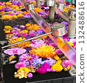 A flower water basin with vibrant flowers floating on the water 132488616