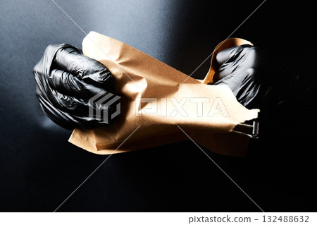 Manicurist hands taking manicure tools from craft envelope before manicure procedure. Manicurist hands taking manicure tools from craft envelope before manicure procedure. 132488632