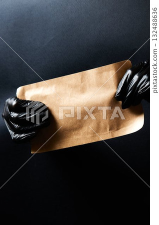 Manicurist hands taking manicure tools from craft envelope before manicure procedure. 132488636