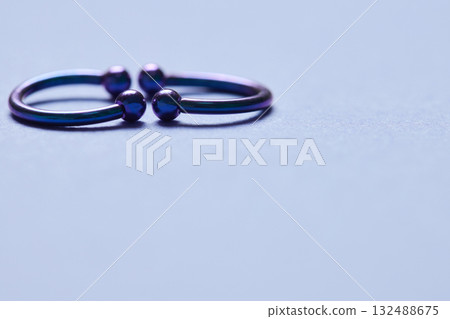 Piercing earrings close-up. On a black background. Piercing earrings close-up. On a black background. 132488675