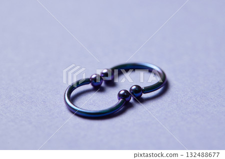 Piercing earrings close-up. On a black background. Piercing earrings close-up. On a black background. 132488677
