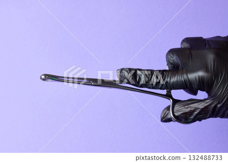 hand-held stainless steel surgical scissors with gloves. 132488733