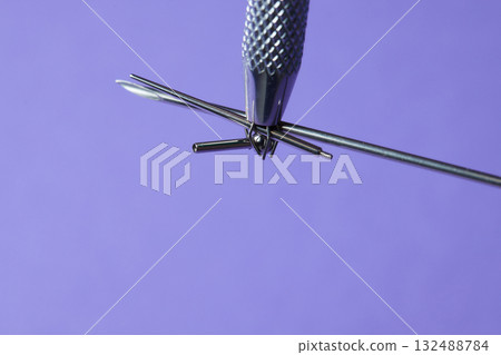 Piercing earrings close-up. On a Violet background. Piercing earrings close-up. On a Violet background. 132488784