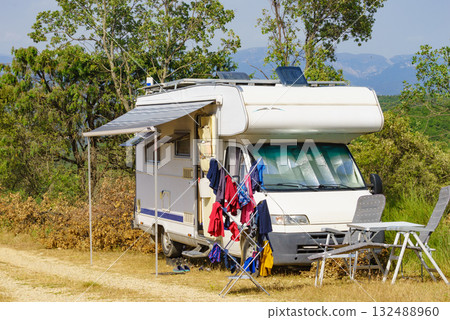 Clothes hanging to dry outdoors by camping car. Caravan vacation. Clothes hanging to dry outdoors by camping car. Caravan vacation. 132488960