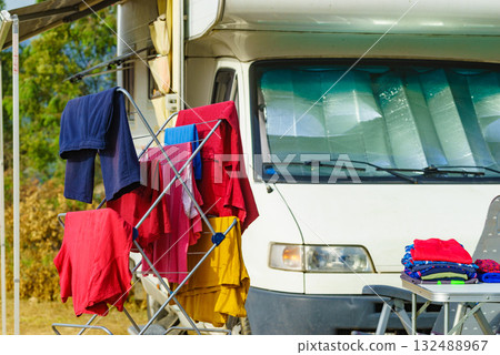 Clothes hanging to dry outdoors by camping car. Caravan vacation. 132488967