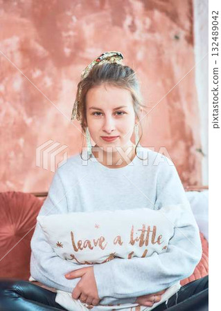 fragile teenage girl in bed hugging pillows 132489042