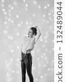 fragile teenage girl surrounded by Christmas lights 132489044