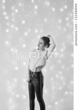 fragile teenage girl surrounded by Christmas lights fragile teenage girl surrounded by Christmas lights 132489044