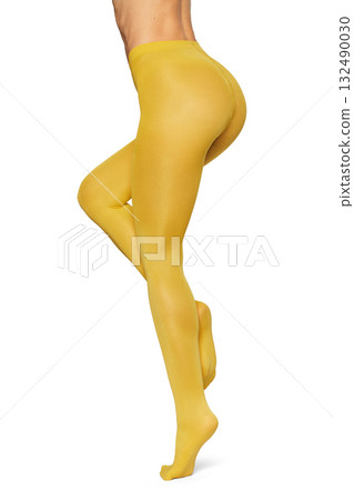 Beautiful long fit female legs in yellow tights on white background Beautiful long fit female legs in yellow tights on white background 132490030