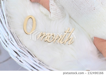 The beginning of a new life is marked with wooden lettering "0 month" The beginning of a new life is marked with wooden lettering "0 month" 132490166