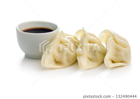 Traditional japanese gyoza dumplings and soy sauce isolated on white background. Traditional japanese gyoza dumplings and soy sauce isolated on white background. 132490444