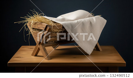 Wooden manger with straw and white cloth, symbolizing Christmas spirit, set on a rustic wooden table, evoking warmth and holiday traditions in a serene atmosphere Wooden manger with straw and white cloth, symbolizing Christmas spirit, set on a rustic wooden table, evoking warmth and holiday traditions in a serene atmosphere 132490512
