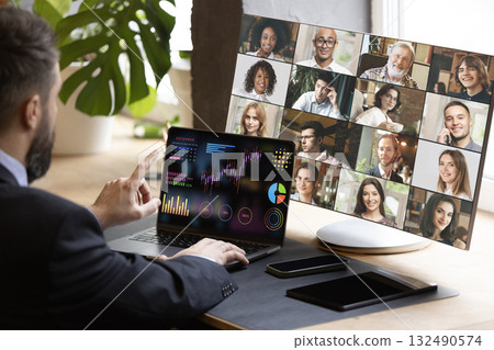 Businessman in virtual meeting presenting financial data charts with confident expression. Bright poster Businessman in virtual meeting presenting financial data charts with confident expression. Bright poster 132490574