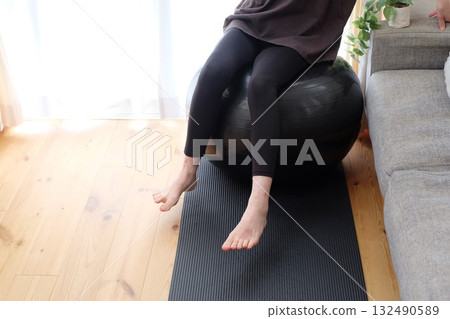 A woman on a balance ball A woman on a balance ball 132490589