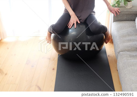 A woman on a balance ball A woman on a balance ball 132490591