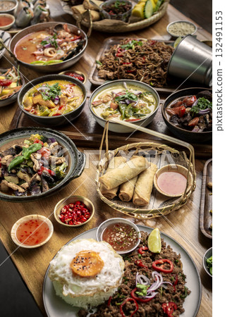 many different thai food dishes on table in modern restaurant in bangkok thailand 132491153