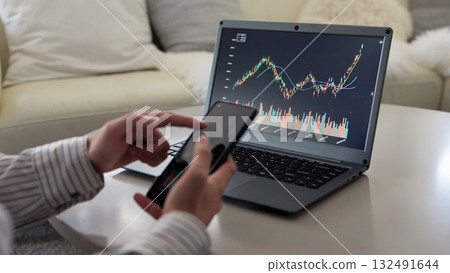 Asian man rejoicing at rising stock prices Asian man rejoicing at rising stock prices 132491644