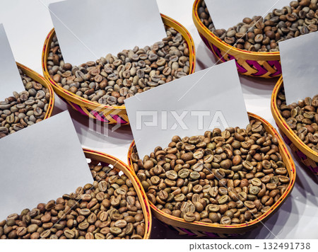 Coffee beans displayed in woven baskets during an agricultural event showcasing local produce and artisanal goods Coffee beans displayed in woven baskets during an agricultural event showcasing local produce and artisanal goods 132491738