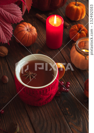 Cozy Autumn Scene with Mulled Wine, Candles, Pumpkins and Seasonal Decor 132492083