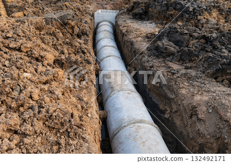 Laying sewer pipes at construction site Laying sewer pipes at construction site 132492171