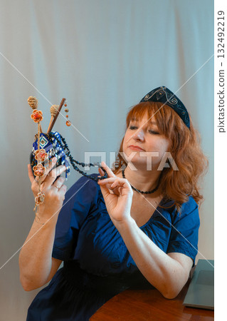 modern woman with elements of ethno-style in a costume uses the technique modern woman with elements of ethno-style in a costume uses the technique 132492219