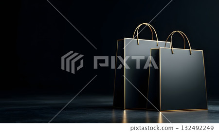 Two elegant black shopping bags with gold accents on a dark background. Ideal for Black Friday sale promotions and retail marketing. 132492249