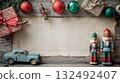 Holiday decorations with nutcracker figures, vintage car, and wrapped gift on rustic wooden table 132492407