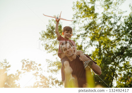 Portrait of happy father with son outdoors.  132492417