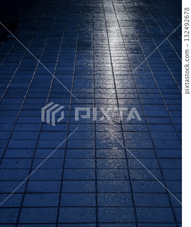 Rain-soaked road surface reflecting streetlights Rain-soaked road surface reflecting streetlights 132492678