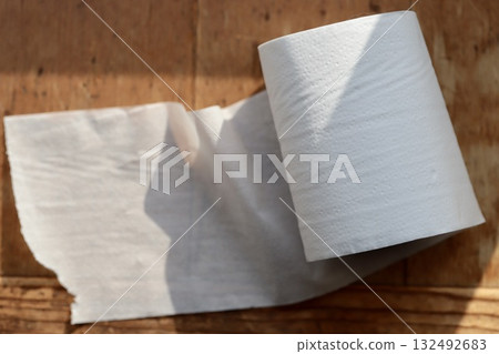 Half-used Japanese double-layer toilet paper roll with core 132492683