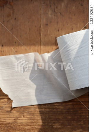 Half-used Japanese double-layer toilet paper roll with core 132492684