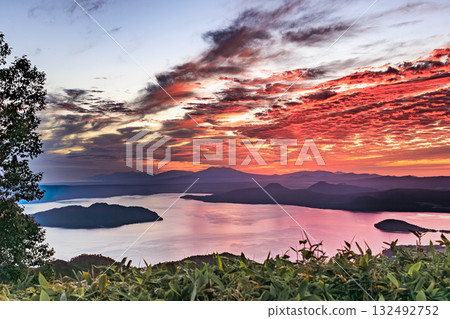 A fiery evening sky over Lake Kussharo - a drama from the northern land 132492752