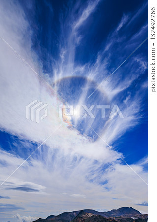 A sky enveloped in light - a fantastical landscape created by a solar halo and clouds 132492766