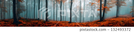 A panoramic view of a misty forest with tall trees. The ground is covered in vibrant orange leaves, creating a serene autumn atmosphere. 132493372