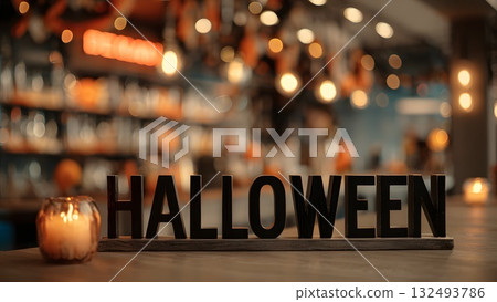 A Halloween-themed setting with a wooden sign spelling 'HALLOWEEN' in focus. Soft candlelight illuminates the scene, creating a festive atmosphere. A Halloween-themed setting with a wooden sign spelling 'HALLOWEEN' in focus. Soft candlelight illuminates the scene, creating a festive atmosphere. 132493786
