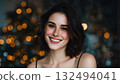 Smiling young Caucasian woman with short dark hair, festive background with Christmas lights, celebrating New Year 2026. 132494041