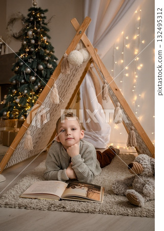 Child Reading Inside Cozy Indoor Teepee During Holidays Child Reading Inside Cozy Indoor Teepee During Holidays 132495312
