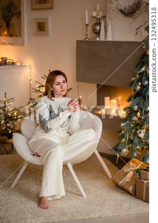 Cozy Winter Evening with Warm Drink by Christmas Tree 132495318