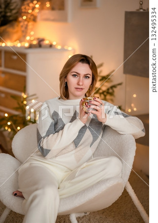 Woman Relaxing with Coffee in Cozy Holiday Atmosphere Woman Relaxing with Coffee in Cozy Holiday Atmosphere 132495334