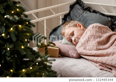 Child Sleeping Peacefully on Christmas Morning Near Gifts Child Sleeping Peacefully on Christmas Morning Near Gifts 132495344