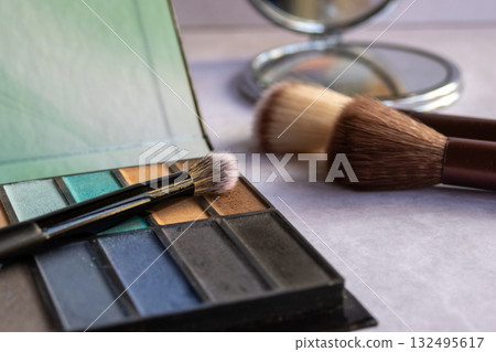 Cosmetic tools and eyeshadow palette in professional studio lighting, perfect for modern beauty branding, skincare promotions and influencer content. Cosmetic tools and eyeshadow palette in professional studio lighting, perfect for modern beauty branding, skincare promotions and influencer content. 132495617