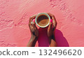 Female hands holding a cup of coffee in the pink background. African woman's hands with a cappuccino mug aerial view. 132496620