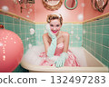 A woman in a pink dress is sitting in a bathtub with bubbles 132497283