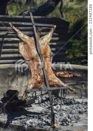 Lamb on the spit, cooked with the traditional Argentine method, La Pampa province, Patagonia, Argentina. Lamb on the spit, cooked with the traditional Argentine method, La Pampa province, Patagonia, Argentina. 132497289